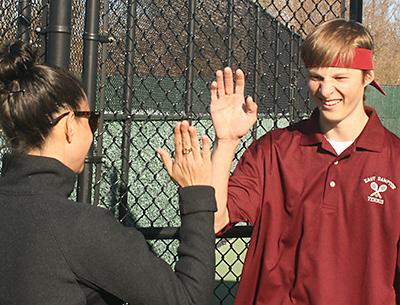 Jordan Foster, whose net play earned the second doubles team the pivotal point in the match with Westhampton Beach, was greeted as he came off the court with a high-five from his coach, Katie Helfand.