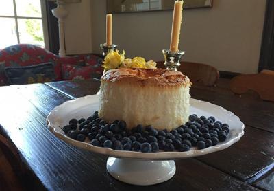 An angel food cake can be flavored with lemon, coffee, or other essences and served with blueberries, as in this version of the dessert classic.