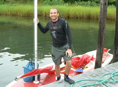 Norris Acosta stood with his Sunfish at Harbor Marina in Three Mile Harbor on Monday. He stopped off for supplies en route from Massachussetts to Brooklyn aboard the small sailboat.