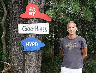 Peter Buchman beside his commemorative Sept. 11, 2001, piece on Route 114, a memorial that he did anonymously