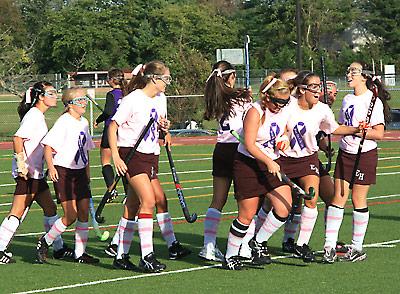 Meghan Dombkowski (with head bowed) was feted following her successful penalty stroke in the first half of Friday’s field hockey game here with Greenport-Southold.