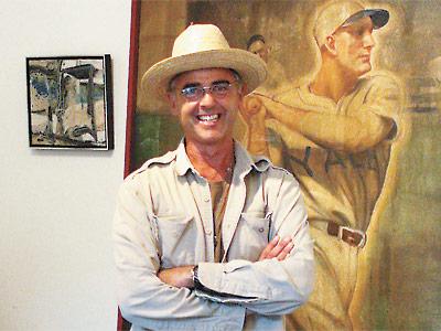 Mark Wilson of Wilsonville surrounded by items from the Amagansett store, including a portrait of an unknown baseball player.