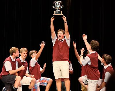 Cameron Yusko hoisted the Long Island trophy the golf team won last spring as his fall teammates knelt worshipfully.