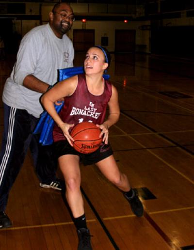 Nicole Miksinski, going to the hoop after having maneuvered around her coach, Howard Wood, during Saturday’s practice session, is expected to be one of the starters.