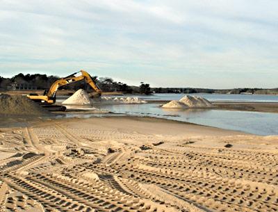 An excavator from the Bistrian Materials company dug sand from the south end of Georgica Pond during the week under contract with the town trustees.