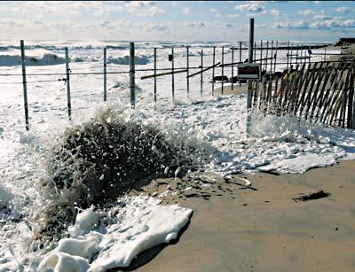 Recent storms have swallowed a big portion of Georgica Beach and focused attention again on an apparently illegally installed fence, which is partially underwater during exceptionally high tides.