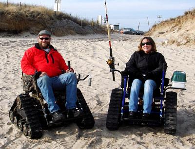 Larry Keller Jr., left, is the exclusive agent for the all-terrain wheelchair without wheels called the Action Trackchair. On Saturday at Ditch Plain, his girlfriend, Sharyn Marks, showed off the chair’s surfcasting potential.