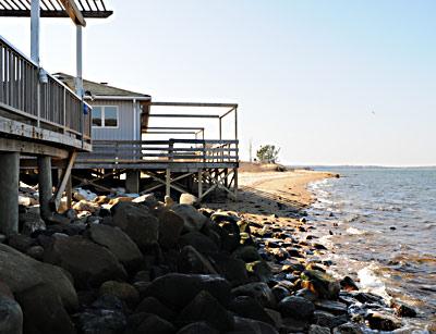 The East Hampton Zoning Board of Appeals is considering an application to tear down and rebuild a house on Mulford Lane in Amagansett, along with the construction of a rock revetment to prevent further erosion.