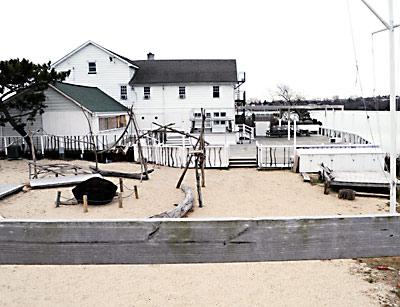 The Surf Lodge is appealing the senior building inspector, Tom Preiato’s, determination that the food cart and the covered wait service area, back right, are an expansion of a nonconforming use. Both structures require a natural resources special permit and a variance since Fort Pond is at the edge of the deck.