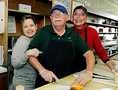 A week of warm farewells have descended upon Bucket’s owner, Everett Griffiths, seen here in the embrace of a longtime employee, Tammi Gay, and Mr. Griffith’s wife, Angela.