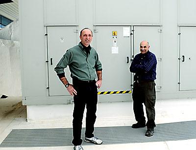 Eric Woellhof, the director of facilities, seen here on the high school roof with Anthony DeFino, a colleague, has instigated initiatives that have led to the district receiving a rebate from the Long Island Power Authority.