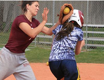 School of Hard Knocks: Lia Makrianes, a freshman, who was taken onto the varsity this spring, found herself frequently confronted at the plate by Kathryn Hess, the senior catcher, during Saturday morning’s practice.