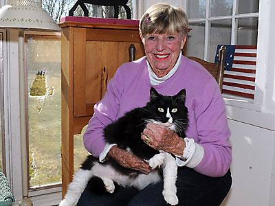 Joan Tulp with a furry friend in her Gansett Lane living room.