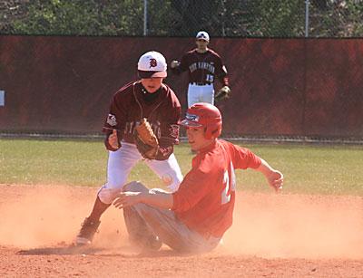 A rare sight: an Amityville player sliding safely into second in the first game of April 9’s doubleheader here.