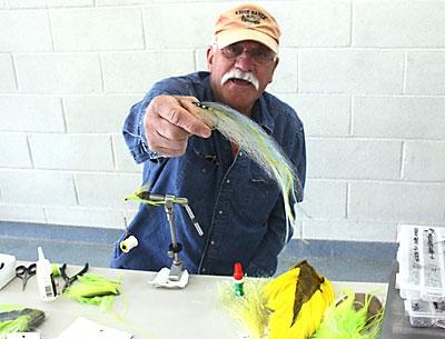 During the Sportsmen’s Expo held at the Amagansett Firehouse on Saturday, Alfonso Marino displayed a fly he’s tied to lure big striped bass.