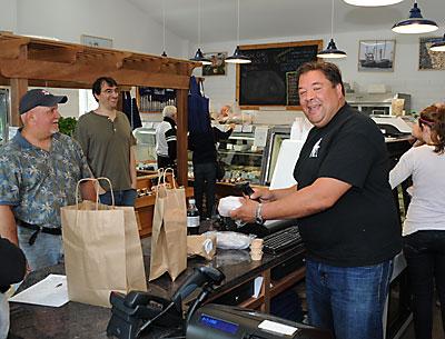 Hampton Seafood’s owner, Peter Ambrose, serves up to-go dishes like duck tacos, made-to-order sushi rolls, and other daily selections at the new store on Race Lane in East Hampton.