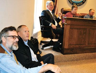 Anton Hagen and Brendan Skislock sat on the floor near Assemblyman Fred W. Thiele Jr., and the board members Bruce Stafford and Edward Gregory at Tuesday’s hearing on a law that would allow ferries to dock in the village.