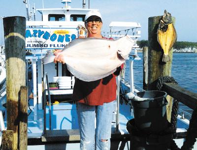 Kathy Vegessi strained her biceps to hold up the 8.5-pound fluke she caught during a busman’s holiday aboard the Lazy Bones party boat on Sunday. Her husband, the Bones’s captain, Mike Vegessi, has been finding the big ones.