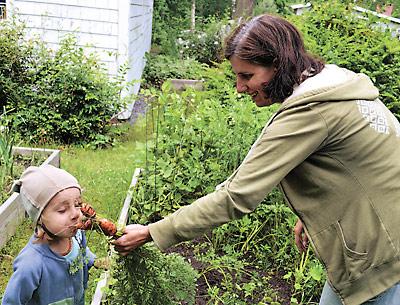 Mare Dionara’s son, Finny, enjoyed the smell of carrots pulled from their backyard garden, where they hope to have chickens.