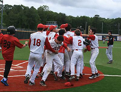 How sweet it was: The freshman pinch-runner, Jack Fitzpatrick, was mobbed after scoring the game-winning run in the bottom of the seventh.