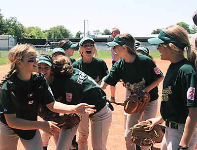 The Sand Gnats jumped around after winning the Little League girls softball “world series.”