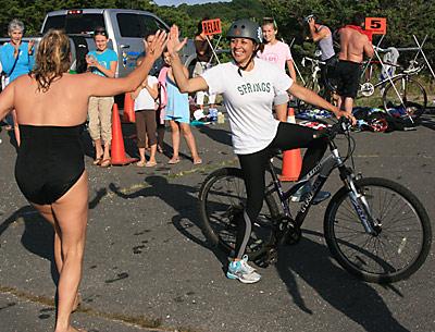 Ana Jacobs, who did the bike leg of a relay team whose other members were Kim Notel and Eric Casale, the Springs School’s principal, exchanged a high-five with a swimmer as she set out.