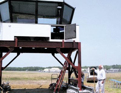 Air traffic controllers will be on the job tomorrow morning in the new control tower at East Hampton Airport, directing traffic in and out of the airport between 7 a.m. and 11 p.m. each day. Town Councilman Dominick Stanzione, at right, coordinated the effort to gain federal approval for the tower and get it in place.