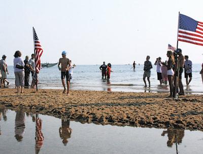 Griffin Taylor, of New York City and Montauk, winner of the one-mile swim, was the first of the some 170 participants to exit the water.