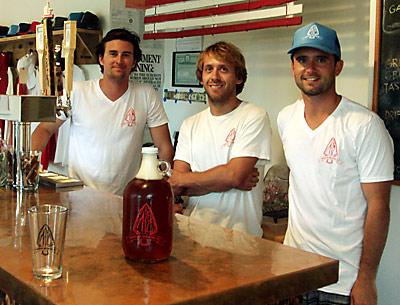 The brains behind the brew at the new Montauk Brewing Company, from left, Joe Sullivan, Eric Moss, and Vaughan Cutillo, worked the tap at the brewery off Edgemere Street on Sunday.