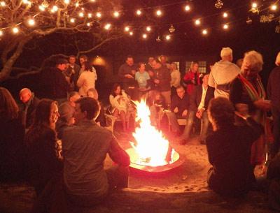 People gathered around a fire in the courtyard at Solé East during a fund-raiser there in June. The resort has announced plans for a three-day music, yoga, and fashion festival next month.