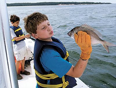 Mason Cohen of Water Mill greeted a porgy up close and personal during an outing provided by the Flying Point Surf School’s fish camp last week.