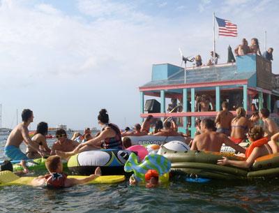 Revelers surrounded a floating stage at an annual boat party Sunday afternoon near Sag Harbor.