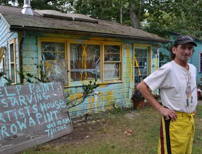 Rian White responded to an East Hampton Town citation about peeling paint on his house by inviting passers-by to help decorate it in whatever fashion moves them. He provided the supplies.