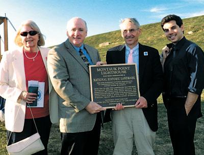 With the presentation of a plaque at a party on Aug. 22, the Montauk Lighthouse officially became a National Historic Landmark. At the event were, from left, Eleanor Ehrhardt of the Lighthouse committee, Robie S. Lange, historian of the National Parks Service, Robert J. Hefner, a historic preservation consultant who worked with Ms. Ehrhardt to receive the recognition, and Scott Martella of Gov. Andrew M. Cuomo’s office.