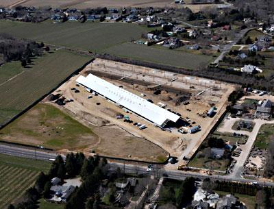 The new Parrish Art Museum is only weeks away from opening to the public and days away from the staff’s moving into new offices. An aerial view shows the museum in an earlier state. At top, two views of the gallery spaces in the Water Mill building.