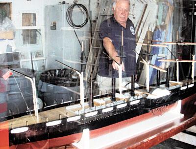 Brian Pope, assistant site manager of the Montauk Lighthouse Museum, pointed to one of two side wheels on a scale model of the S.S. Great Eastern purchased by the museum in August. The model is being readied for display.