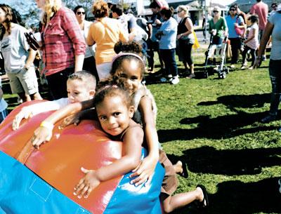 Liliana and Isabella Hopson got a bit impatient waiting their turn for an inflatable slide at the Montauk Chamber of Commerce fall festival on Saturday.