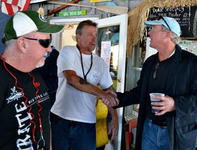 Charlie Canavan, right, thanked the owner of Billy’s on the Bay in Greenport on Saturday, one stop on his Sag Harbor Hysterical Society boat poker run.