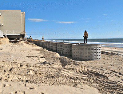 More than a dozen concrete drainage “rings” have been buried on the Montauk beach in front of the Royal Atlantic and Ocean Beach motels, after storm-induced erosion threatened buildings. East Hampton Town officials are investigating the work, as a permit issued specified only the placement of sand.