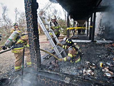 A volunteer firefighter emerged from a lower level at the Sea Crest motel on Napeague following a fire there on Nov. 7 that destroyed several units.