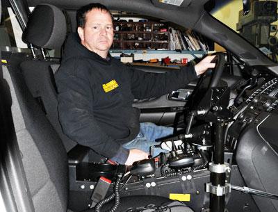 Tom Bono, a mechanic at the East Hampton Town garage, is in charge of wiring the console of the Ford Taurus Interceptor, the newest police vehicle in the department fleet.