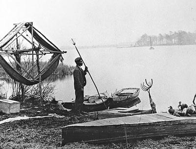 Thomas Hill with eel spear and fishing equipment in a photo taken by Francis Harper in 1910.