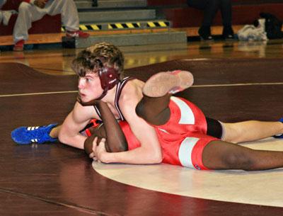 Kevin Boles checked with his coaches moments before he was declared the winner by pin at 112 pounds.