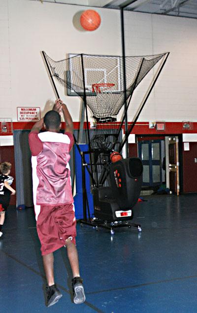 The conical mesh net around the hoop not only funnels balls into the dispatching machine, but also is set at a height that only accepts soft arc shots, not line drives.