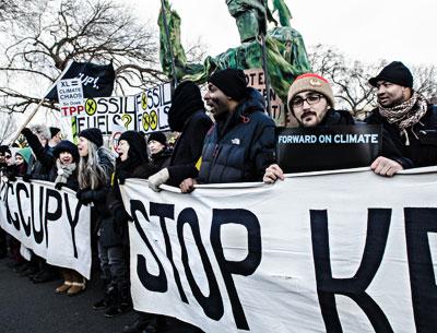 Dan Asselin, second from right, served as a volunteer bus organizer for Forward on Climate, a rally to combat climate change held in Washington, D.C., on Sunday.