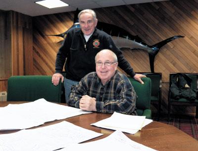 Montauk Fire Chief Rich Schoen, standing, looked at maps that Peter Joyce, a fireman and former chief, has identified as being among the most vulnerable to damage should a storm like Hurricane Sandy hit Montauk.