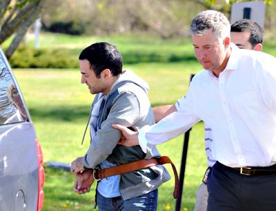 Harry Dalian, left, at his arraignment Friday on charges that he impersonated a police officer during a visit to the John M. Marshall Elementary School in East Hampton on May 1.