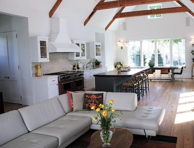 Long-leaf yellow pine beams and flooring, collected by Bryan Gosman, imbue the open living area with warmth.