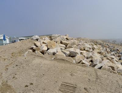 A newly expanded stone revetment that stands between the Montauk Shores Condominium and the Atlantic Ocean is under investigation to determine whether it was installed according to permit specifications.