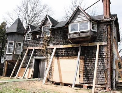 The temporary wooden buttresses in front of the Moran house, pushing up and back against the tilting structure, will give way soon to steel support beams.